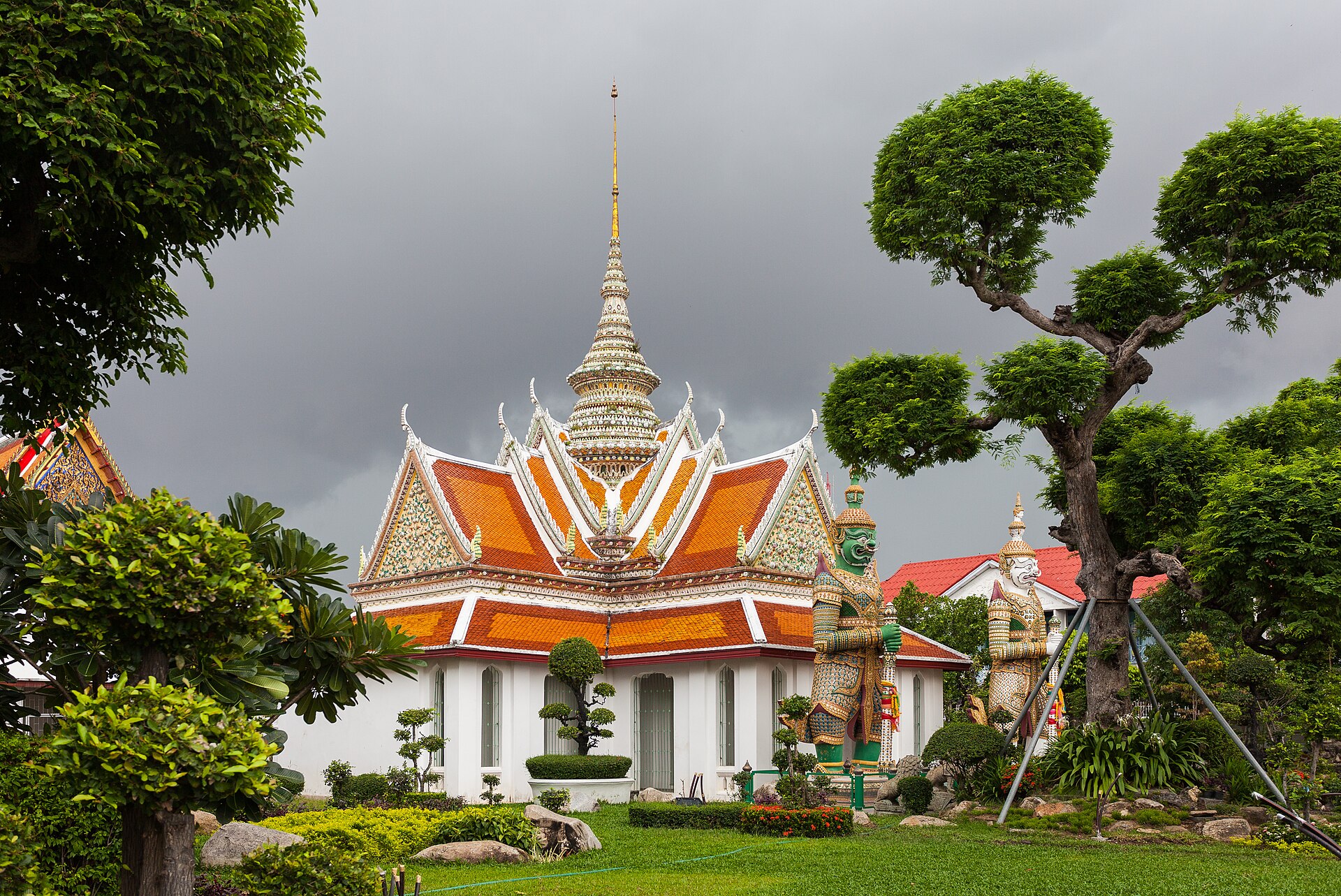 Wat Arun temple beside the Chao Phraya river in Bangkok at dusk